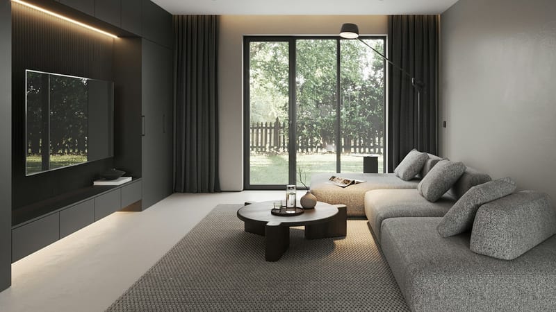 Salón oscuro con un televisor grande encastrado en la pared, una mesa baja y un sofá gris